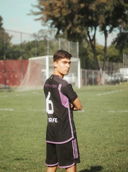 Teen soccer player posing confidently on an outdoor field in Guadalajara, Mexico.