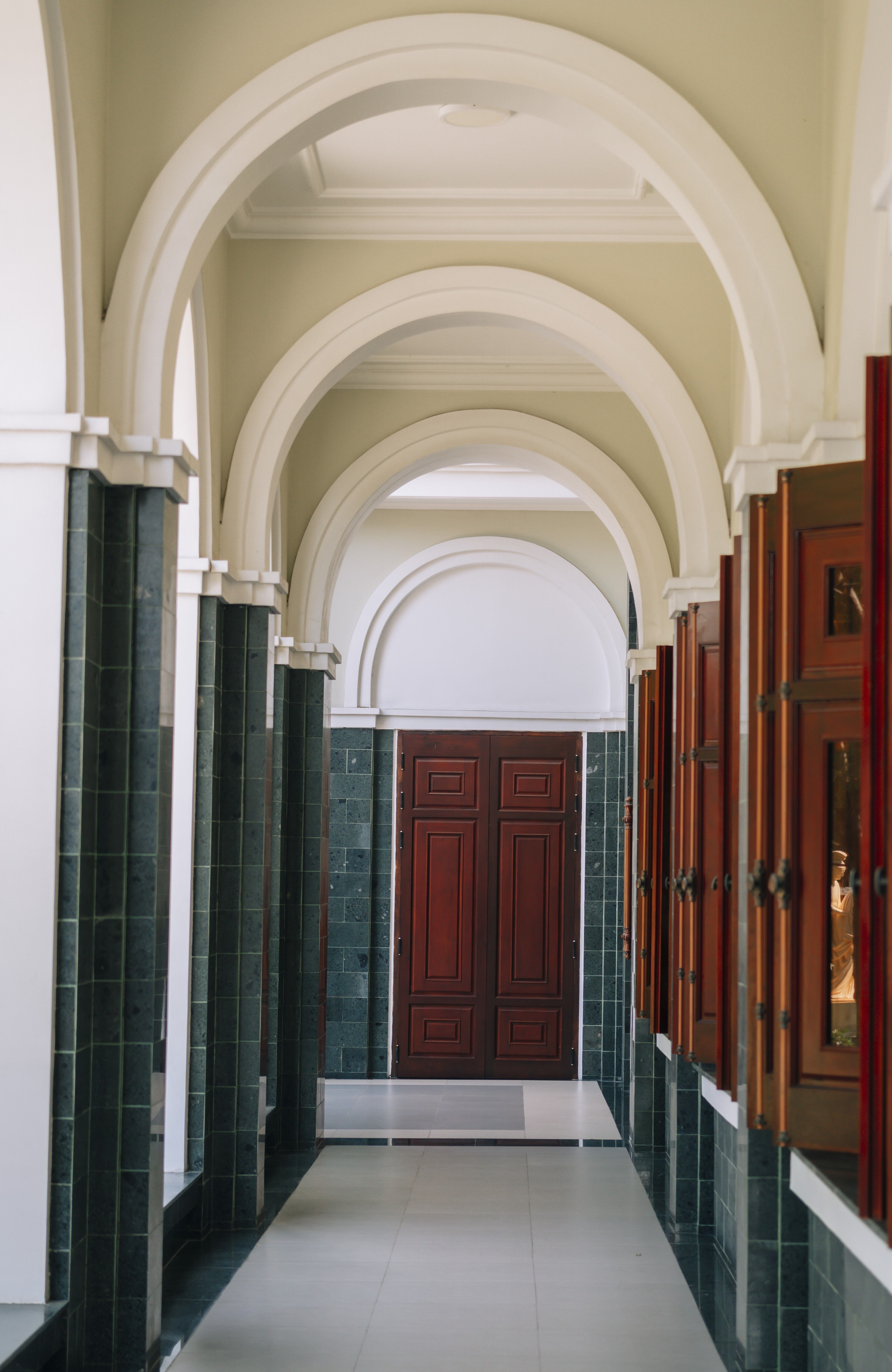 sunlit hotel hallway with arches