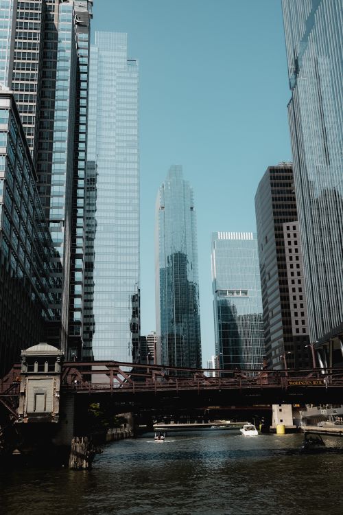 Free View of Chicago's towering skyline and iconic bridge over the Chicago River. Stock Photo