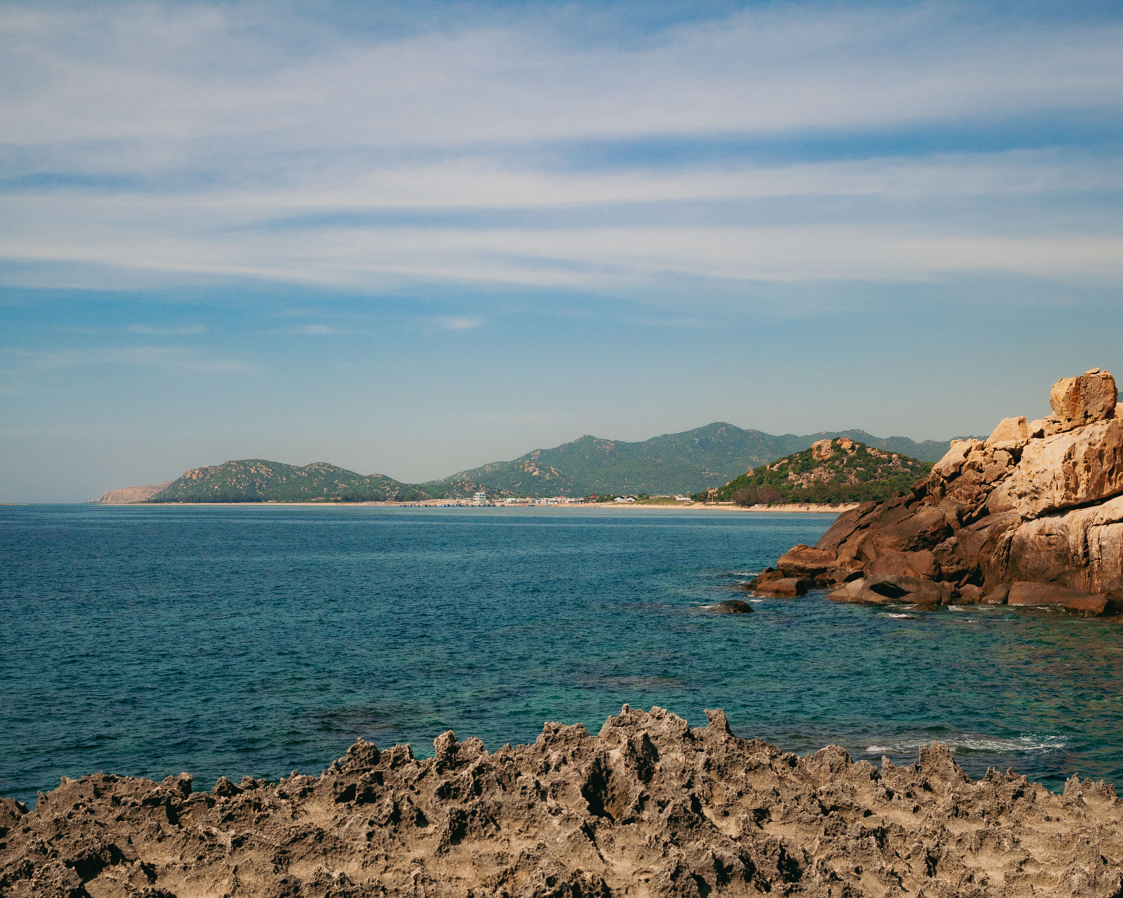 Picturesque seascape with rocky cliffs and blue ocean in Phan Rang, Vietnam.