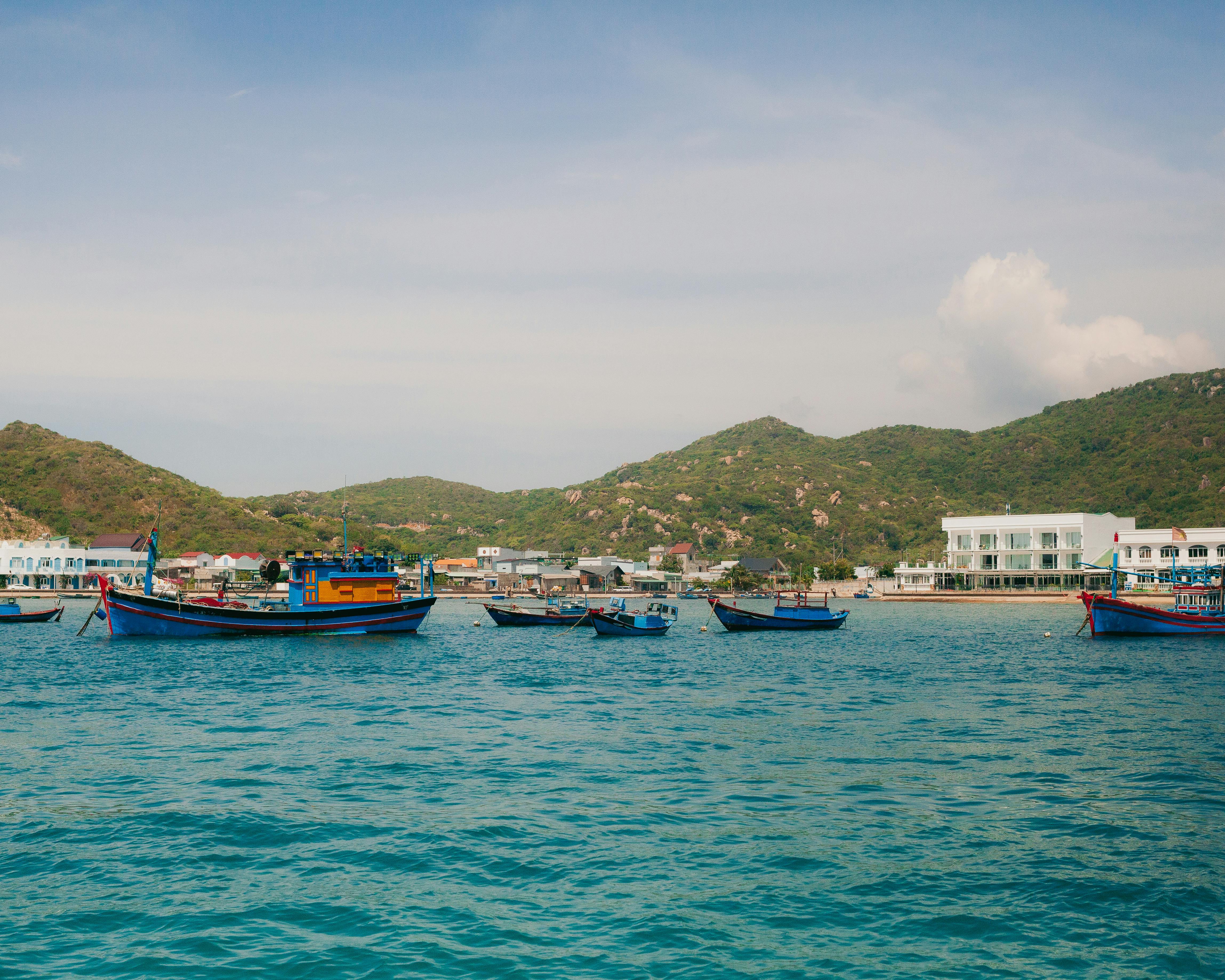 Colorful fishing boats anchored in Vinh Hy Bay, Ninh Thuận, Vietnam on a sunny day.