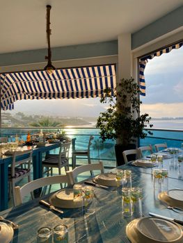 Enjoy serene seaside dining with ocean views and luxury seating.