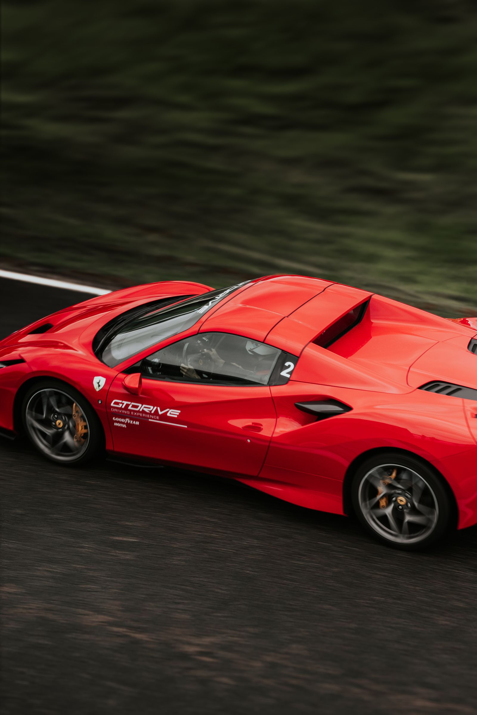 Supercar remapping UK: a red supercar at speed on a race track