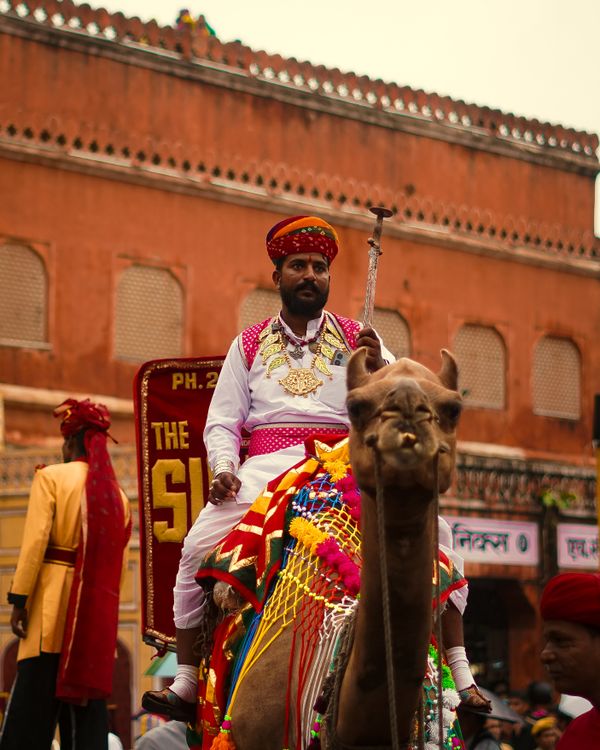 Traditional Camel Riding A man in traditional clothing riding a camel · Free Stock Photo