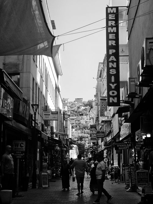 Free Black and white photo of a busy urban street market with people and signs in Istanbul. Stock Photo