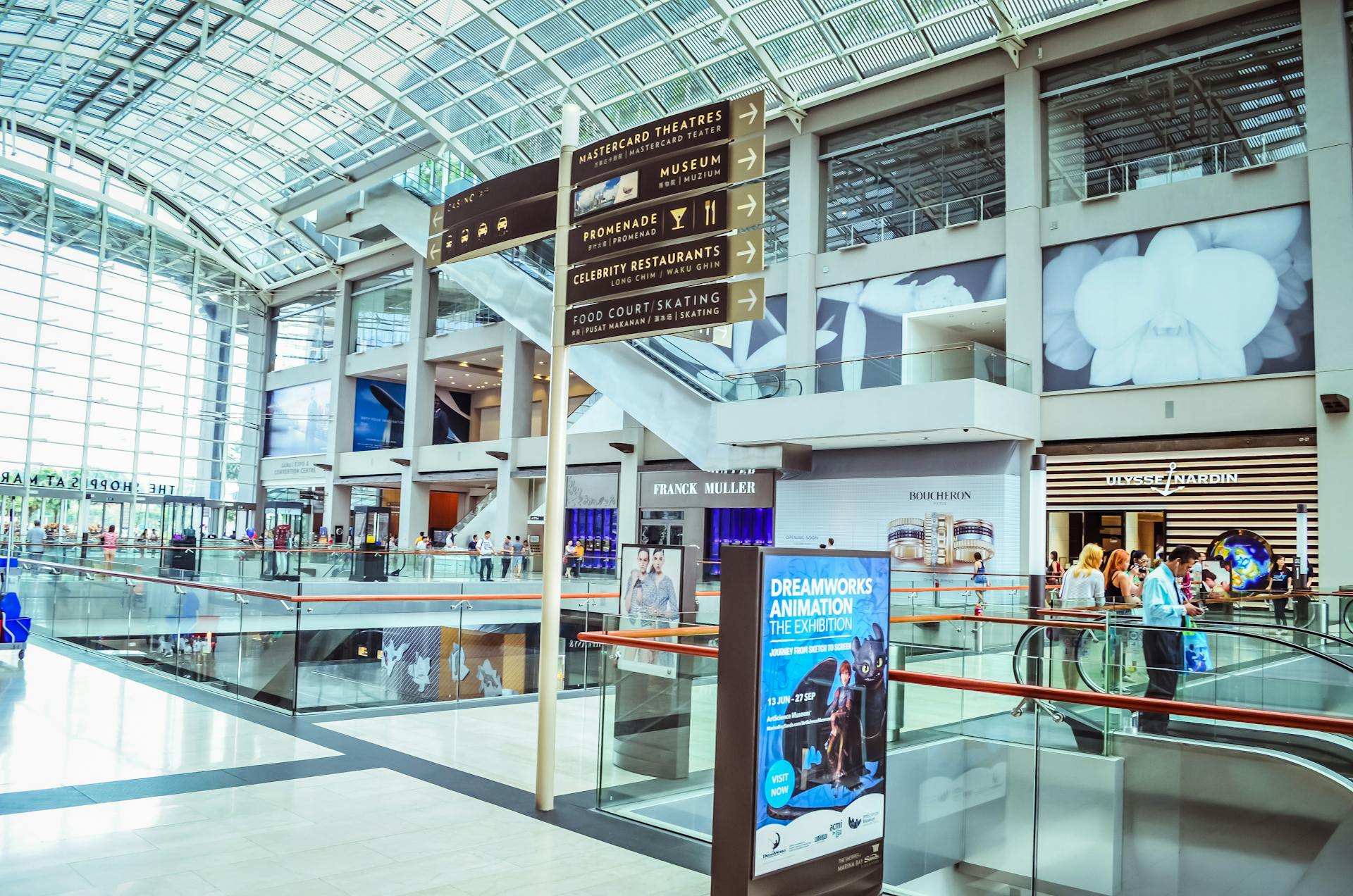 Explore the vibrant interior of Singapore's iconic shopping mall featuring modern architecture and bustling activity.