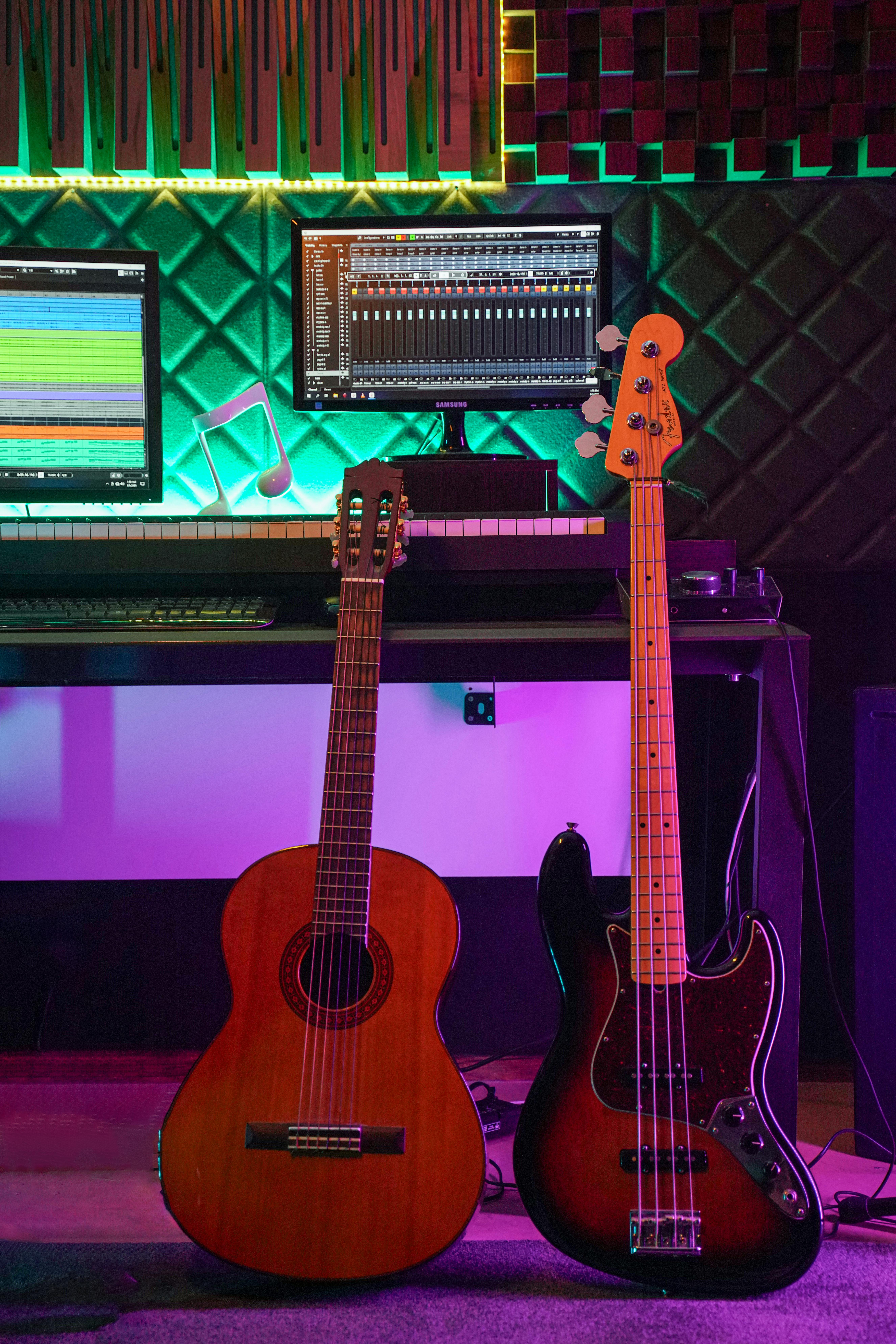 A modern music studio featuring acoustic and electric guitars with vibrant lighting and equipment.