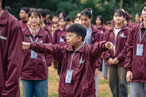 Free Teenagers engaging in a coordinated outdoor exercise in matching jackets. Stock Photo