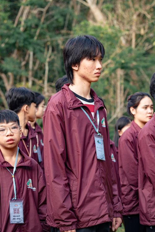 Free Group of multicultural teenagers lined up outdoors wearing matching uniforms. Stock Photo