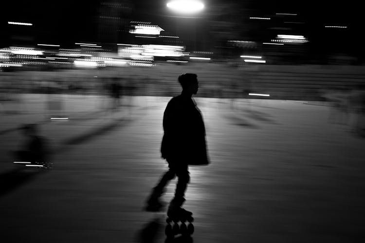 Monochrome Photo Of Person Roller Skating