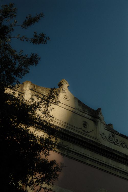 Free A historic building facade with ornate design under dramatic twilight lighting. Stock Photo