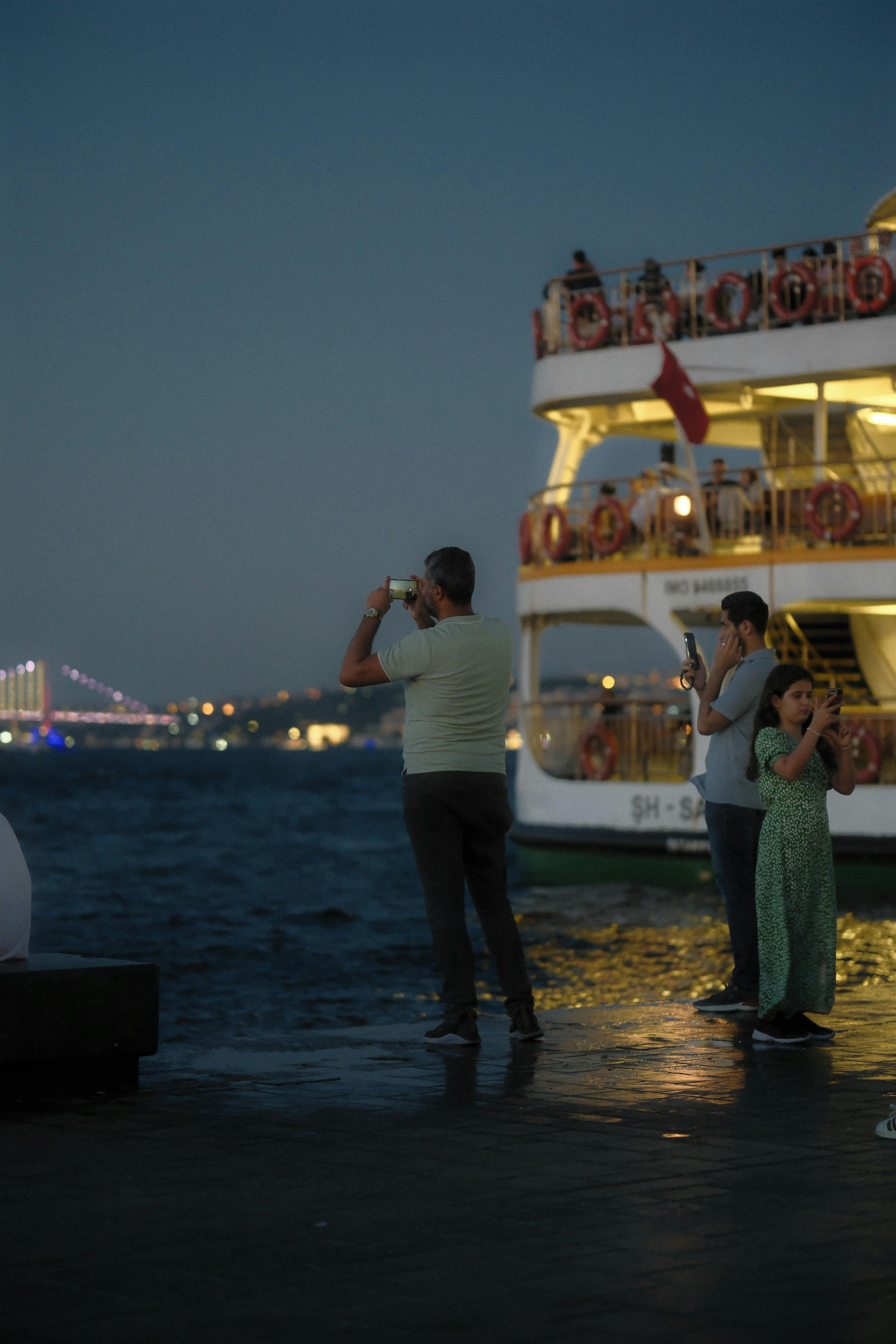 a group of people standing on a dock near a boat