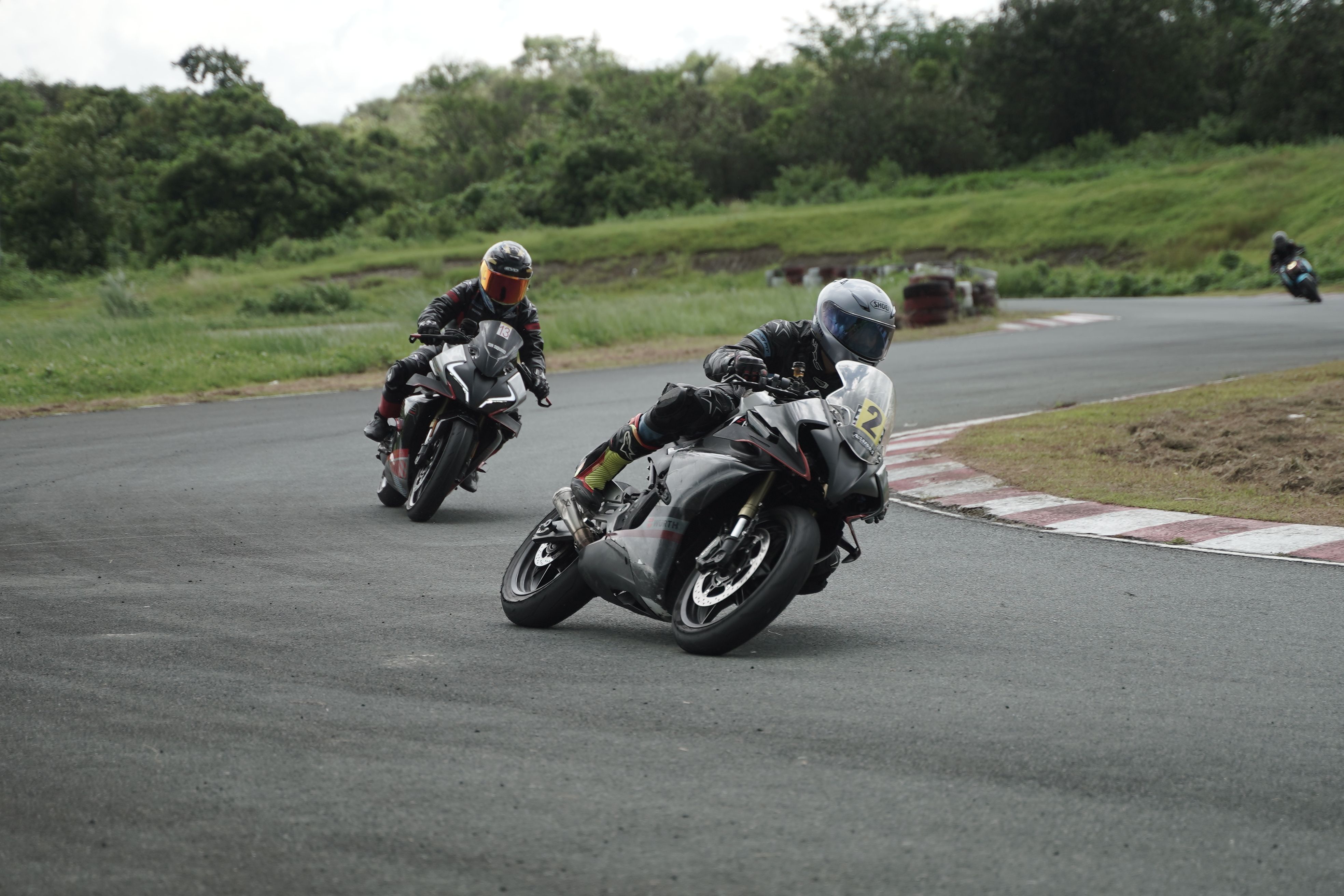 Two motorcyclists are racing on a track · Free Stock Photo