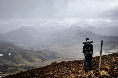Free A lone hiker treks through Landmannalaugar, Iceland, showcasing breathtaking mountain landscapes. Stock Photo