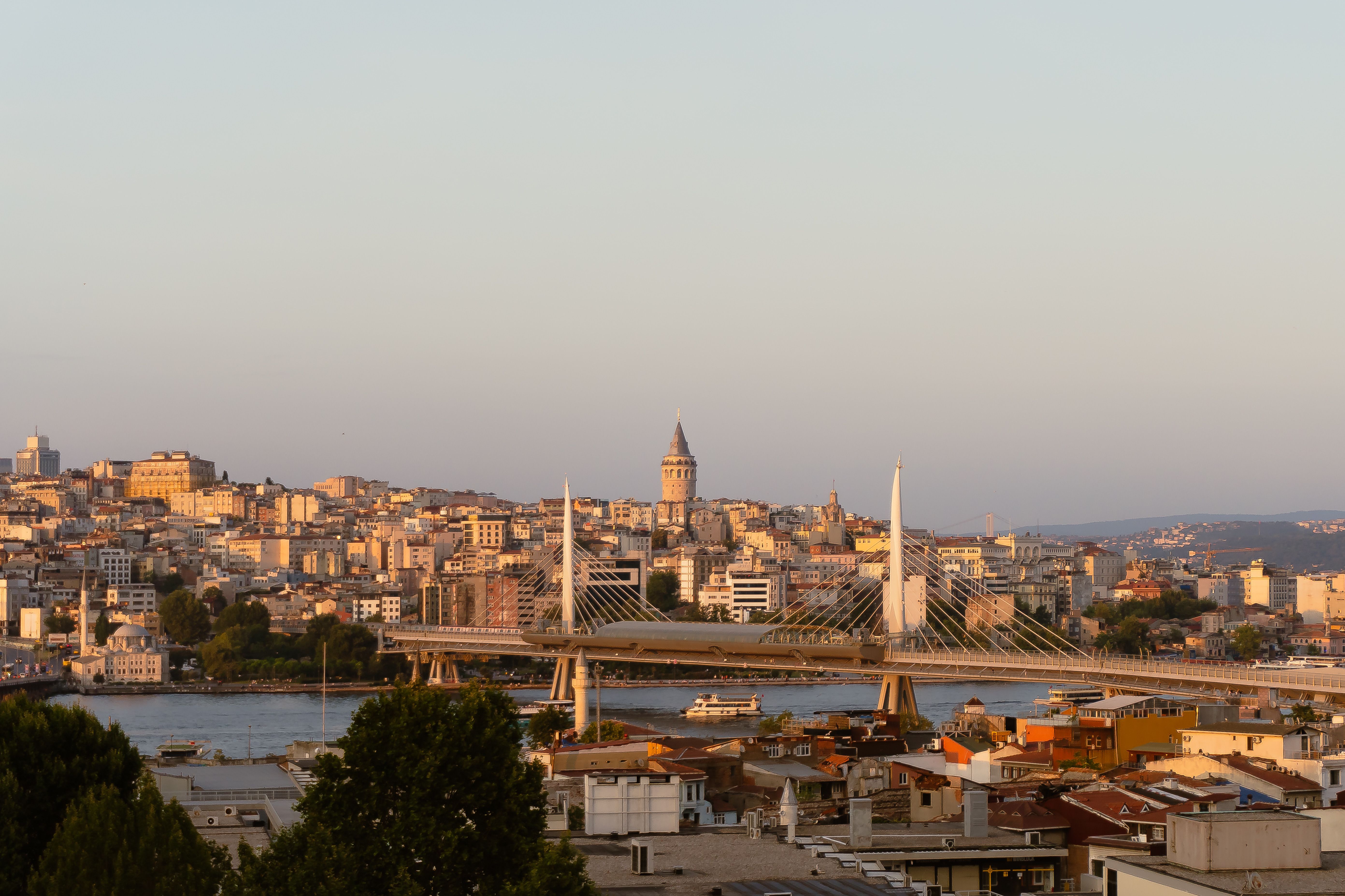 Stunning view of Istanbul's cityscape featuring Galata Tower and Golden Horn at sunset.