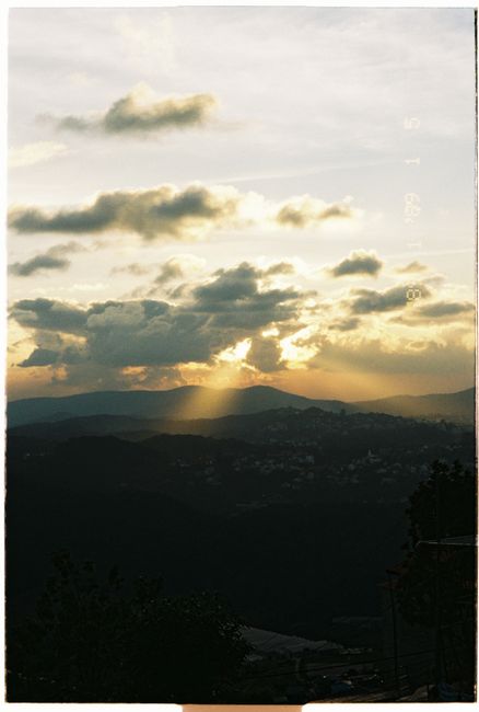 Stunning sunset with dramatic clouds over mountain range, perfect for nature enthusiasts.