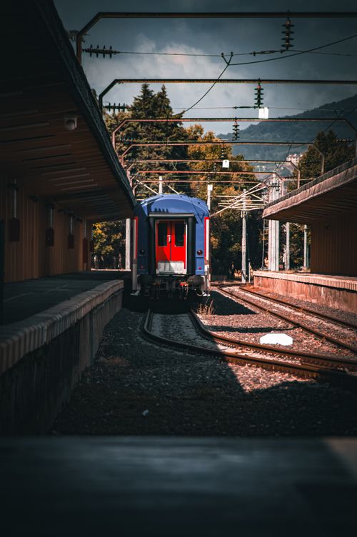 Free A solitary train at a scenic mountain railway station during the day. Stock Photo