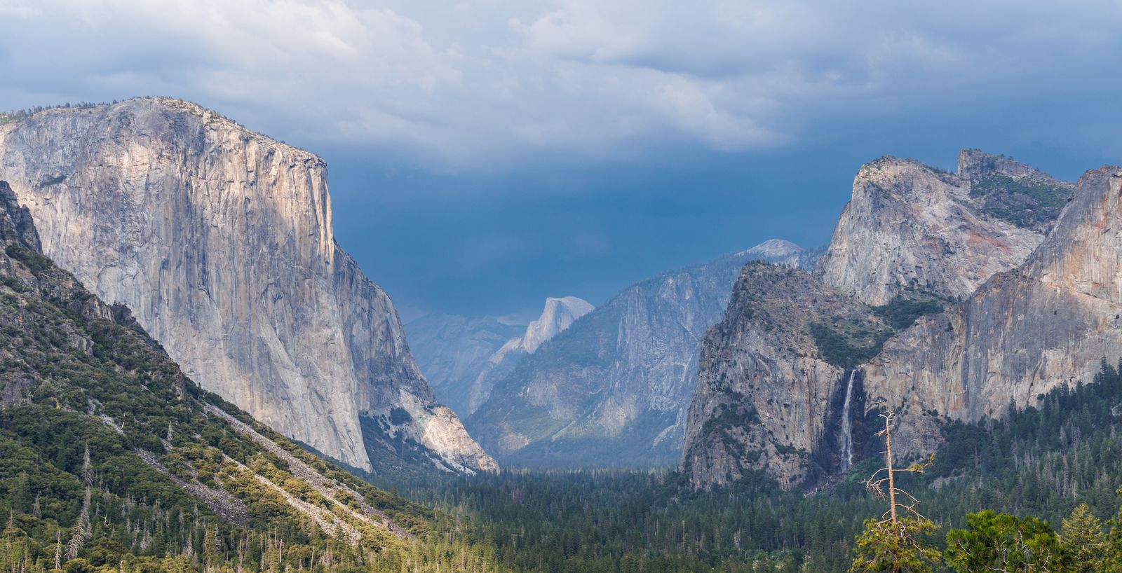 Yosemite Valley with El Capitan and Half Dome under dramatic clouds