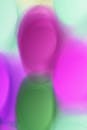 A colorful abstract background with a pink, green and purple ball