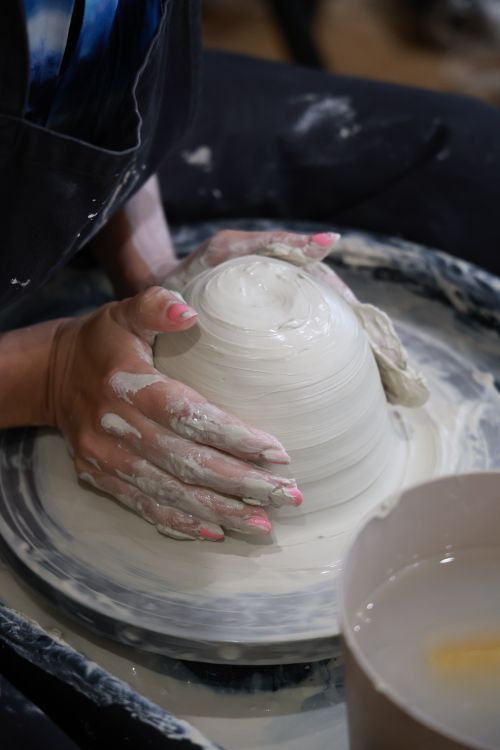 Free Hands molding clay on pottery wheel, capturing the art and skill of ceramics. Stock Photo