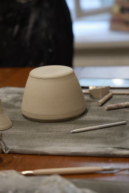 Unfired clay vessel on a studio bench — photo by Dmitry Ovsyannikov on Pexels