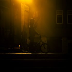 Bikes parked along a city street at night — photo by Sayefotograf on Pexels