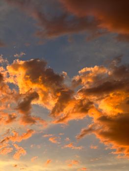 Stunning sunset clouds with vibrant orange hues over Delicias, Mexico, creating a dramatic sky scene.