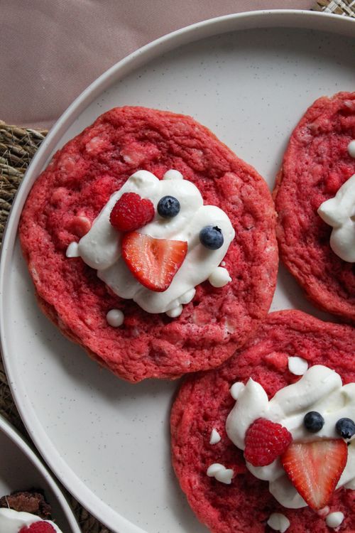 Free Delicious pink pancakes topped with berries and whipped cream. Stock Photo