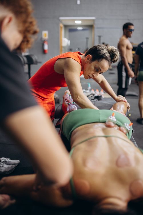 Free A therapist administers cupping therapy on an athletic individual in a gym setting. Stock Photo
