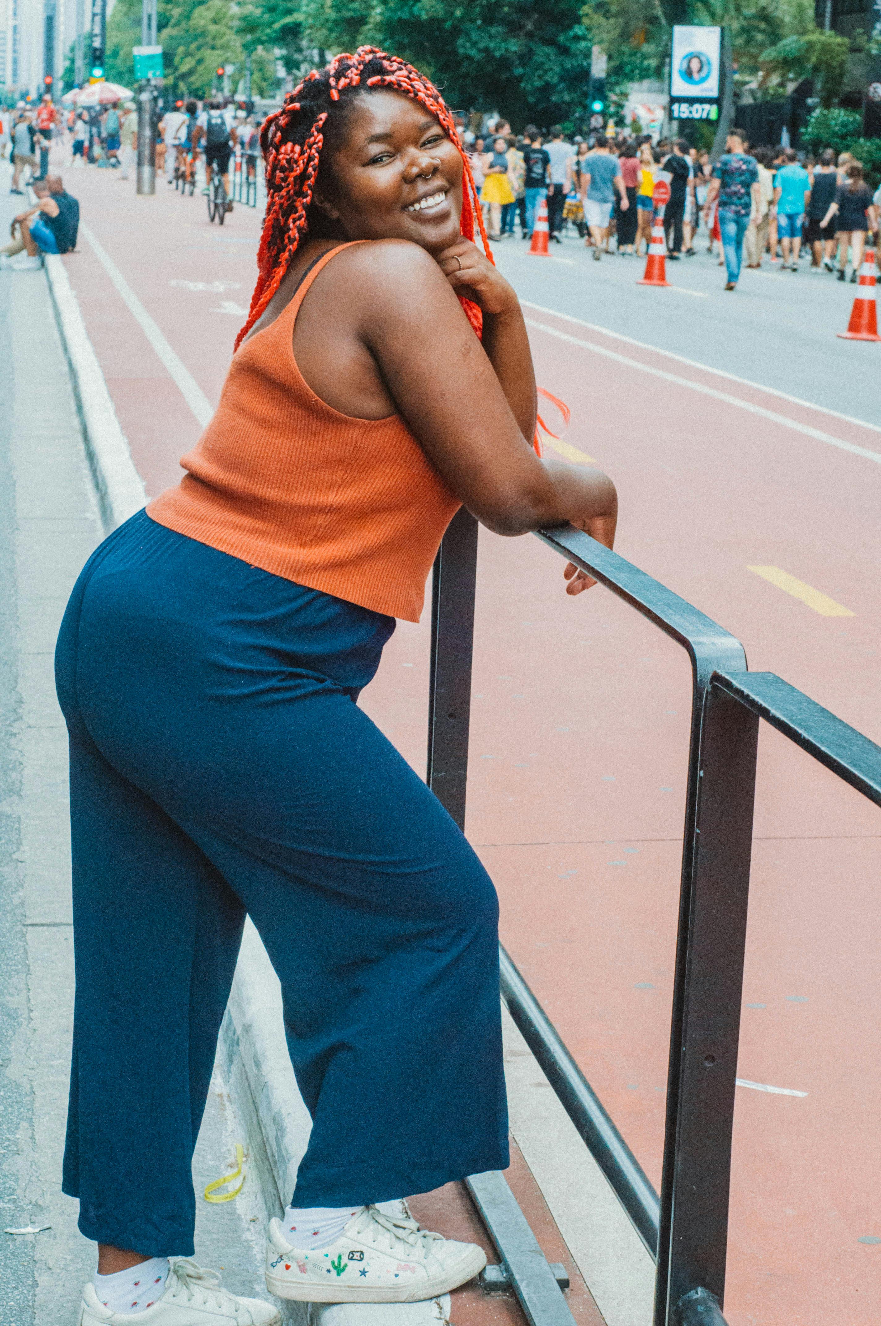 a woman in a blue pantsuit is posing for a photo