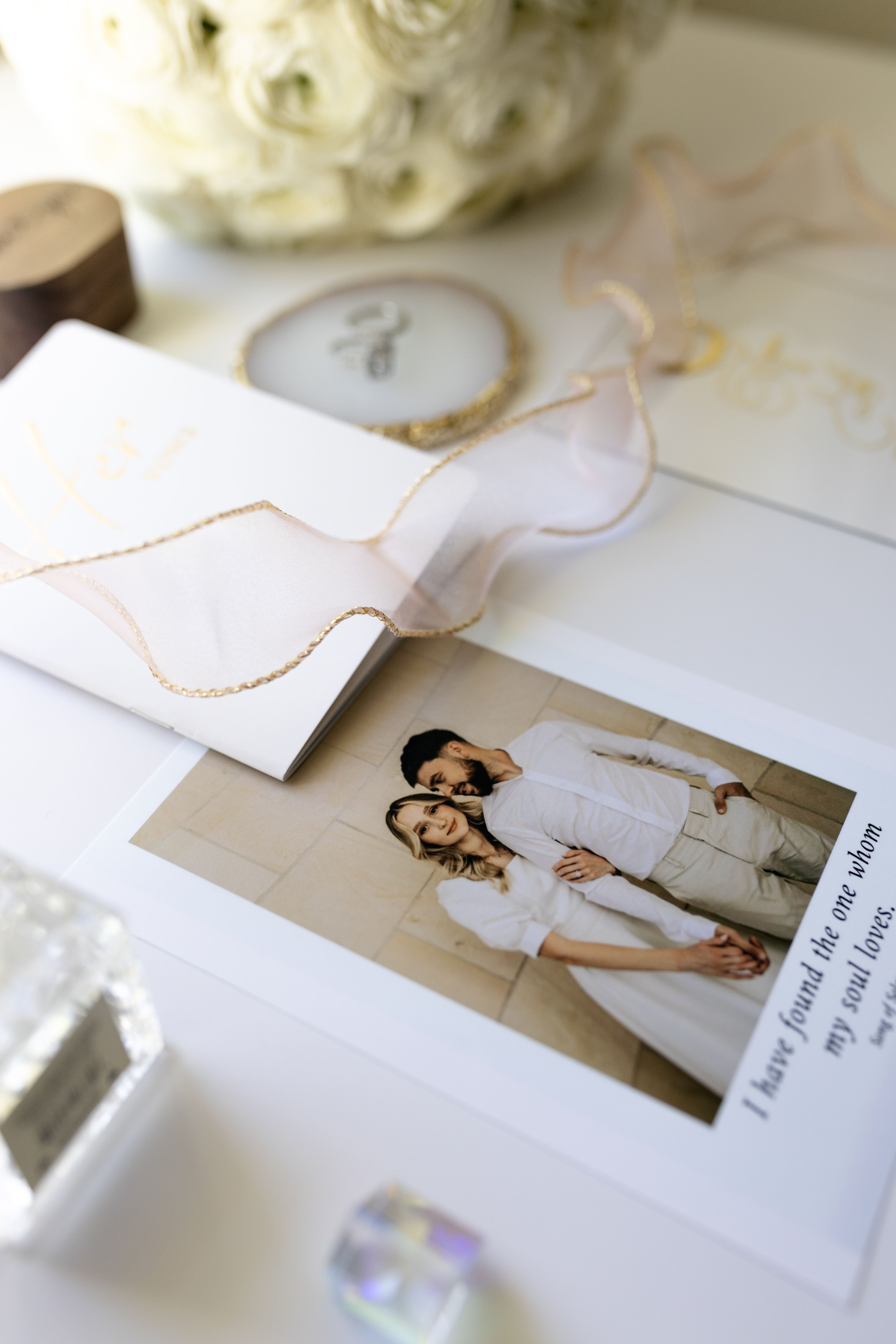 Wedding photographs and stationery arranged together