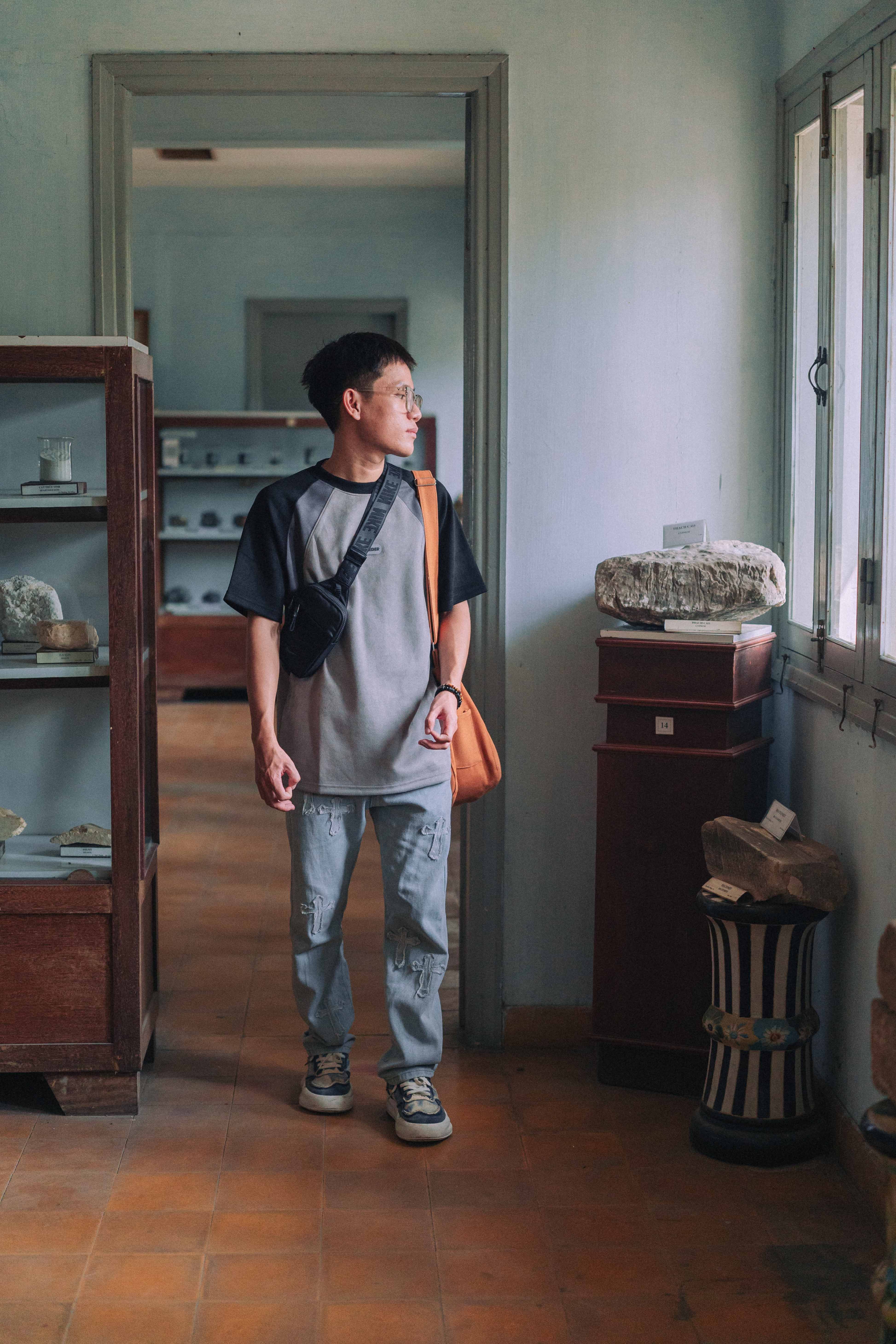 A man standing in a room with a suitcase