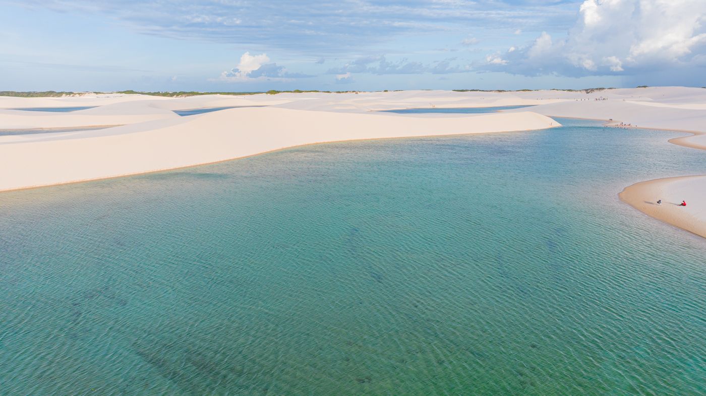 White sand dunes and turquoise rainwater lagoons in Lençóis Maranhenses National Park, Brazil, seen from the air