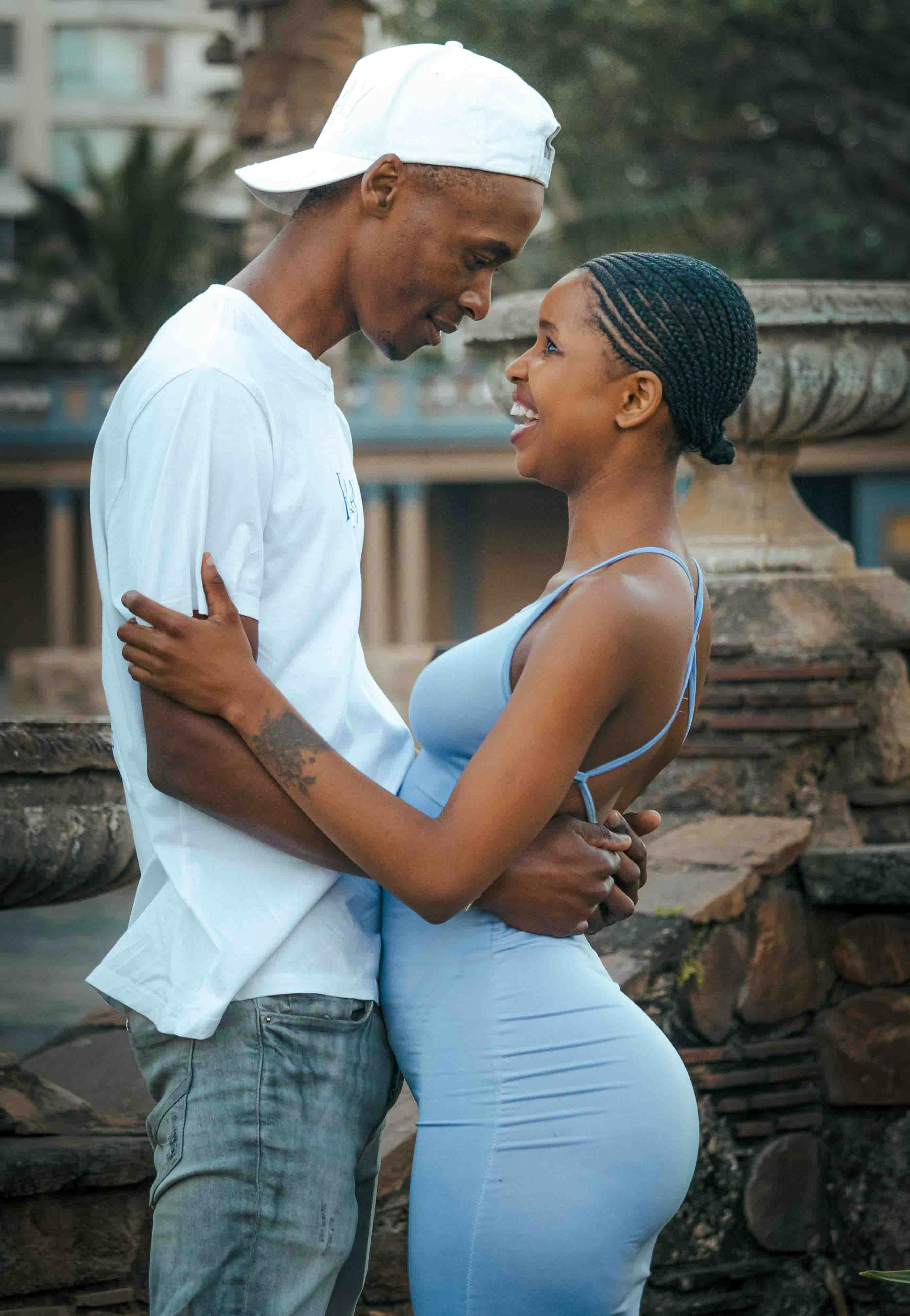 A joyful couple embracing outdoors, showcasing love and happiness.