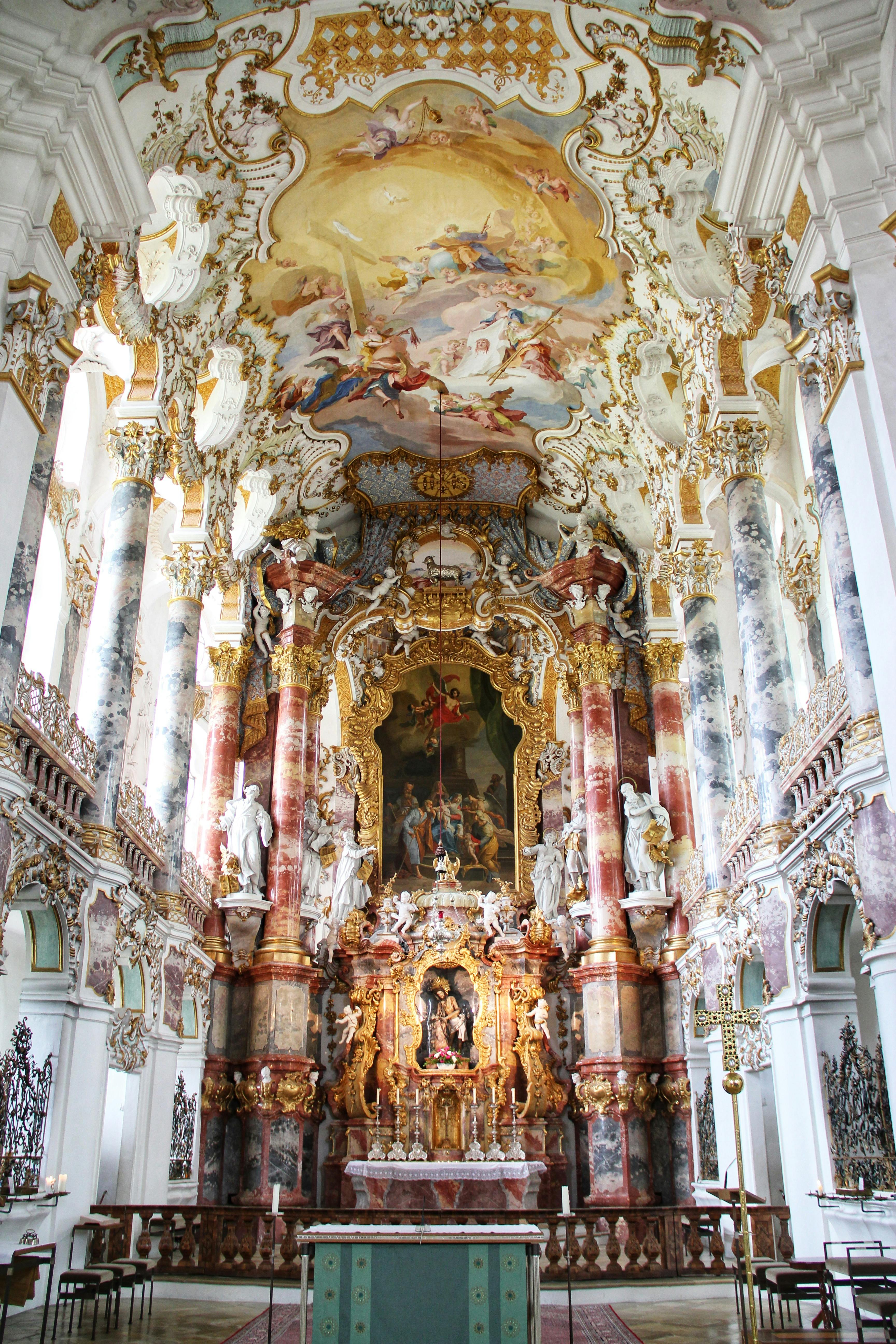 the interior of a church with gold painted walls