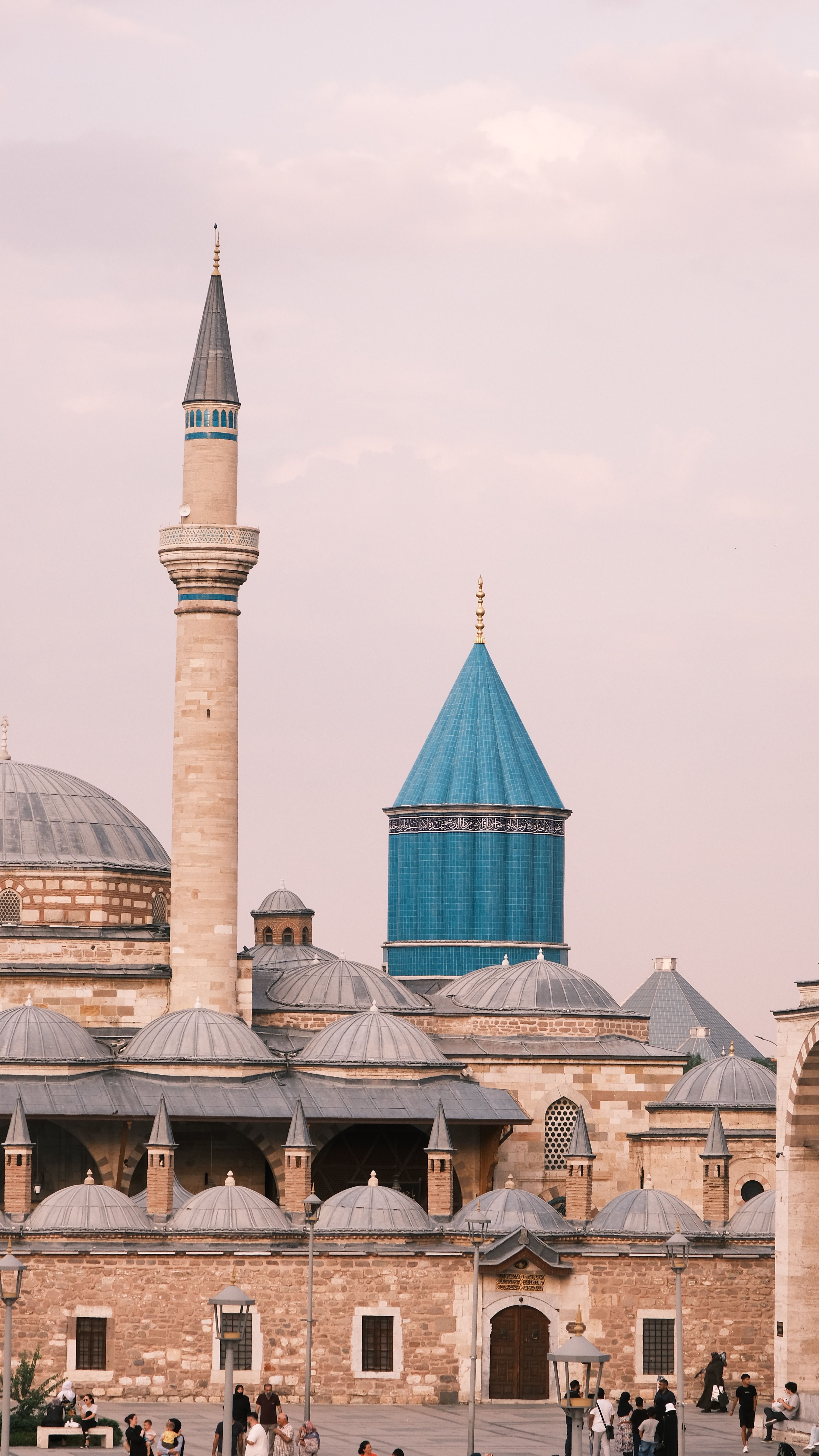 Beautiful view of a historic mosque featuring a towering minaret and intricate domed structures.