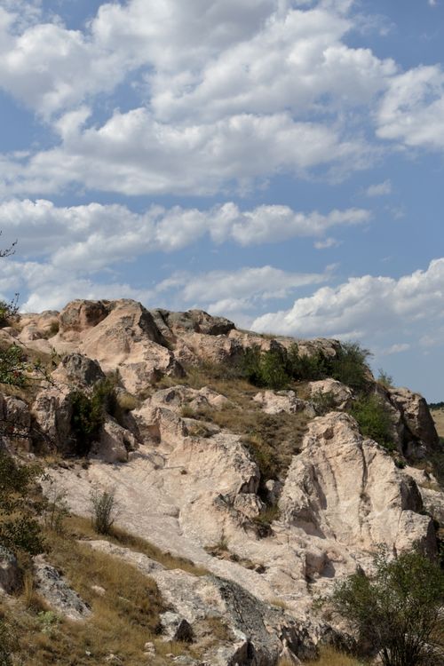 Free Explore a stunning rocky landscape with a backdrop of clouds in the blue sky. Stock Photo