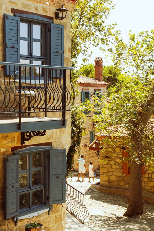 Free Warm summer day in Adatepe, Türkiye, capturing traditional architecture and residents in a quaint street scene. Stock Photo