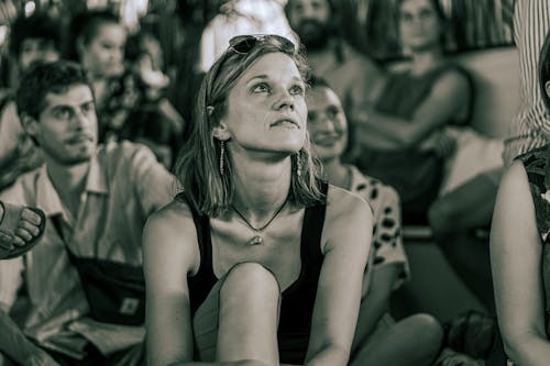 Free A group of people attentively watching an event indoors, highlighting their engagement. Stock Photo