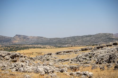 Free Explore the rugged terrain and rocky landscapes of Çermik, Türkiye, under a clear summer sky. Stock Photo