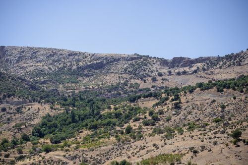 Free Breathtaking view of Çermik's rugged terrain with lush greenery amidst arid hills. Stock Photo