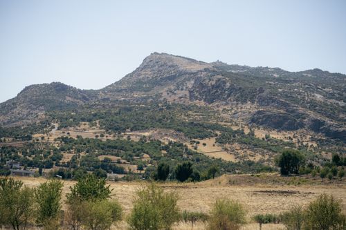 Free Vibrant summer landscape with hills and agriculture in Çermik, Diyarbakır, Türkiye. Stock Photo