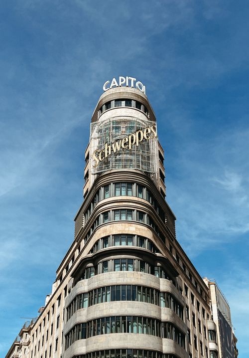 Free View of the famous Schweppes building against a clear blue sky in Madrid. Stock Photo