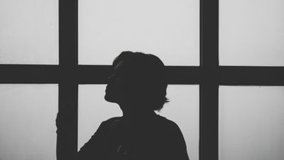 Silhouette of a person at a window — photo by Thunyarat Klaiklang on Pexels