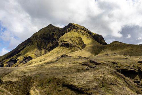 Free Explore the serene beauty of a moss-covered volcanic mountain under a dramatic sky, perfect for adventurers and nature lovers. Stock Photo