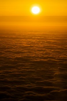 Stunning golden sunset casting warm glow over the cloudscape.
