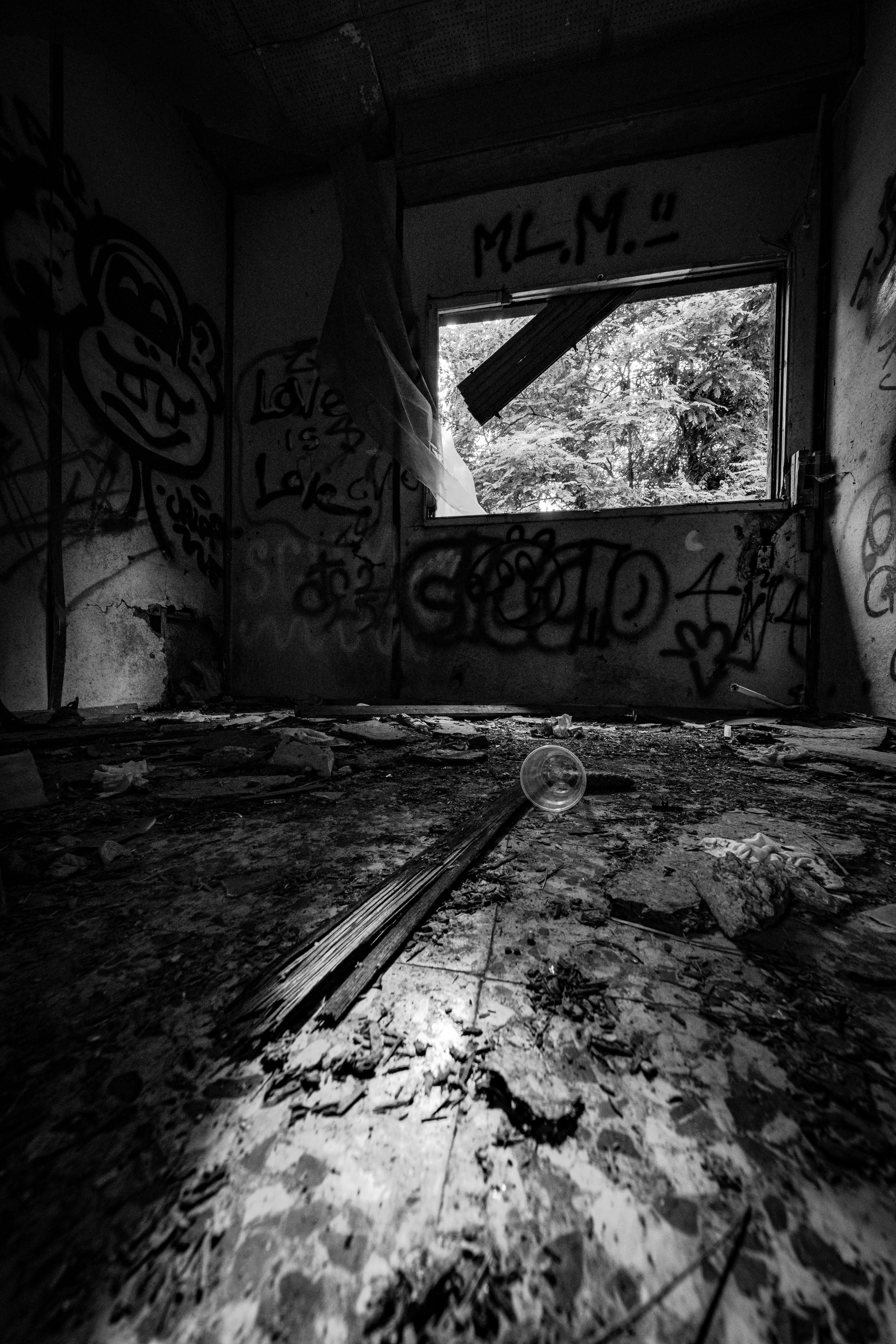 a black and white photo of an abandoned room