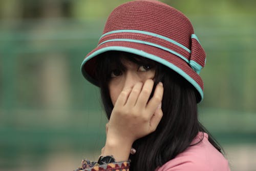 Selective Focus Photography of Woman Holding Her Face