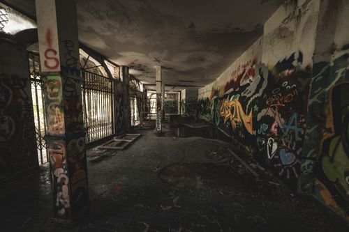 Free Explore abandoned urban tunnel with vibrant graffiti art and mystery. Stock Photo