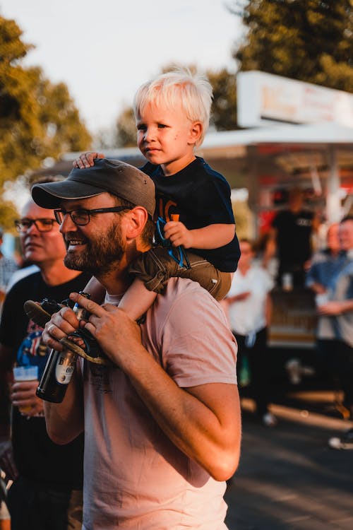 Free Man  Carrying His Son on His Shoulder Stock Photo